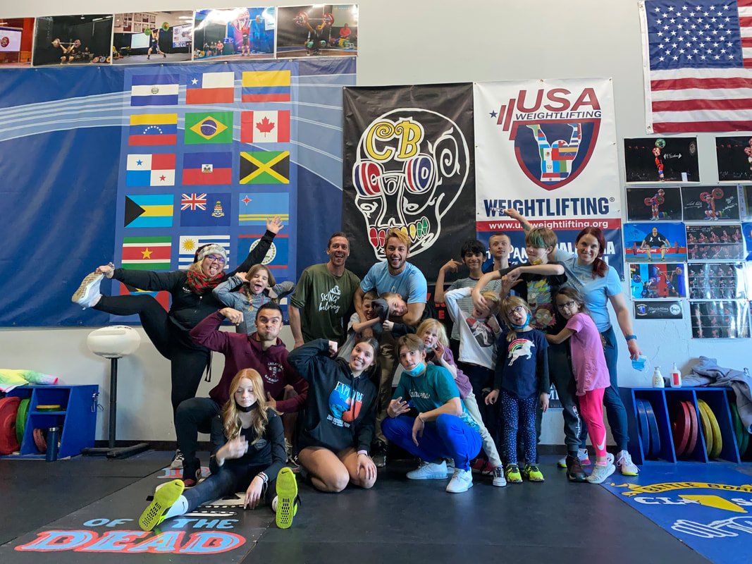 Group photo of campers at a martial arts gym