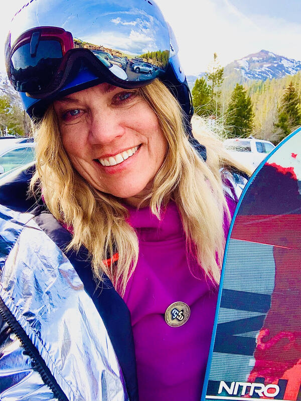 photo of a counselor holding her snow board